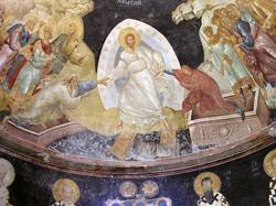 A representation of Jesus clothed in white and surrounded by people.