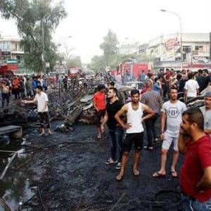 People survey the damage following a deadly bombing in Baghdad's Karada market.