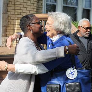 Rev. Desiree Lawson of Trinity United Presbyterian Church and Gail Farnham of PDA Disaster Response Team embrace in Flint, Mich. Photo by Mike Fitzer