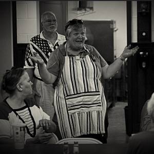 Pastor Nancy Jo Dederer offers a blessing before the community dinner at First Presbyterian Church of Homewood, Illinois. (Photo by Frank Casella)