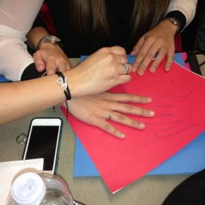 Participants in a seminar at the Presbyterian Ministry at the United Nations organized by the chaplain at Bloomfield College make Red Hands to say children should be children, not soldiers. (Photo by Mark Koenig)