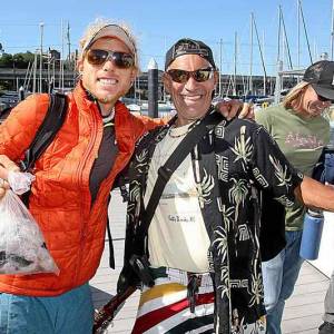 Ryan Althaus of Sweaty Sheep, holds a bag of rock fish filets caught Monday on a boat the Christian group chartered to take two dozen homeless fishing for the day on Monterey Bay, later hosting a fish dinner on the beach. (Phot by Dan Coyro, Santa Cruz Sentinel)