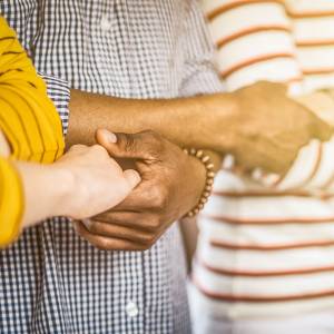 People holding hands in prayer