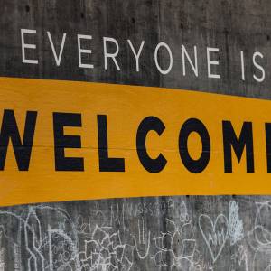 Sign painted on wall that reads: Everyone is Welcome