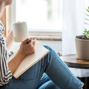 Woman writing in her notebook journal.