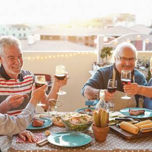 Group of older people enjoying a meal together