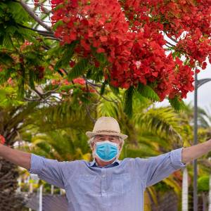 Man with mask stretches out his arms.