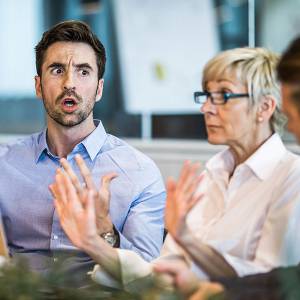 People sitting at a meeting arguing