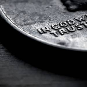 Close-up of U.S. coin showing the words "In God We Trust"