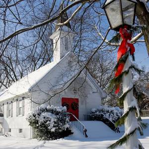 Snow-covered country church at Christmas