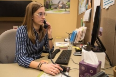 Sammie Smith helps direct a caller at Habitat for Humanity. (Photo by Gregg Brekke)