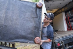 Jeremy Glidden helps a Homeward Bound client move in. (Photo by Gregg Brekke)