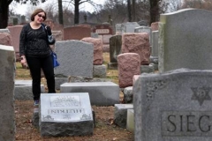 Sally Amon discovers the toppled gravestone of her grandmother Anna Ida Hutkin at Chesed Shel Emeth Cemetery in University City on Feb. 21, 2017. (Photo courtesy of Robert Cohen/St. Louis Post-Dispatch)