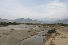 (taken by Rusty Edmondson): A few hours north of Lima, the village of Empedrada was swept away when the Fortaleza River changed course. The river once flowed behind the tree line, but heavy rains altered its path such that it completely removed eleven homes that once stood right where the river flows in this photo. The only indication of their presence is a broken drainage tube poking out of the ground.