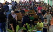 Church members bringing their offerings forward in worship