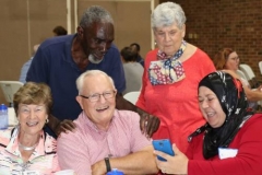 Guilford Park Presbyterian Church members share a moment of laughter with Muslims from the Islamic Center mosque at a covered dish supper after a Ramadan fast on July 2, 2017. (Photo courtesy of Melanie Rodenbough)