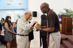 Stated Clerk J. Herbert Nelson II serves Communion at Iglesia Presbiteriana de Puerto Nuevo. (Photo by Gregg Brekke)