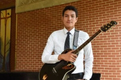 Caleb Chincoya with his guitar after undergraduate chapel at the University of Dubuque. —Nicky Story