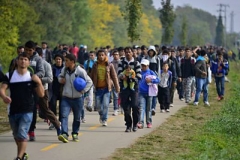 Hegyeshalom, Hungary–October 6, 2015: A group of refugees who arrived by train leave Hungary en route to to Austria and then Germany.