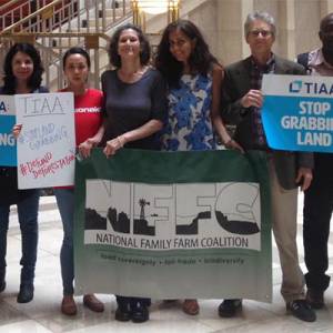 people with signs in TIAA building in DC