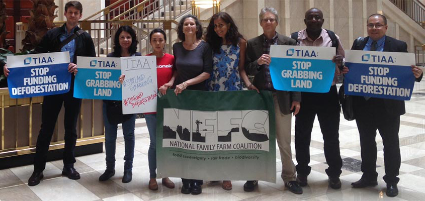 people with signs in TIAA building in DC