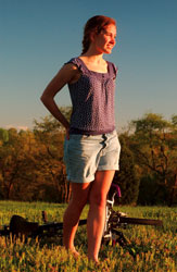 casey in a field with bicycle