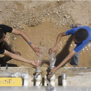 Boys in West Bank filling water bottles