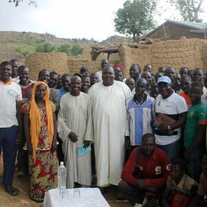 Elias Gondji visiting with villagers in Cameroon.