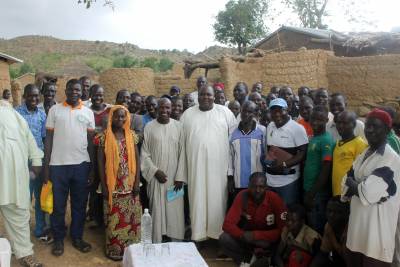 Elias Gondji visiting with villagers in Cameroon.